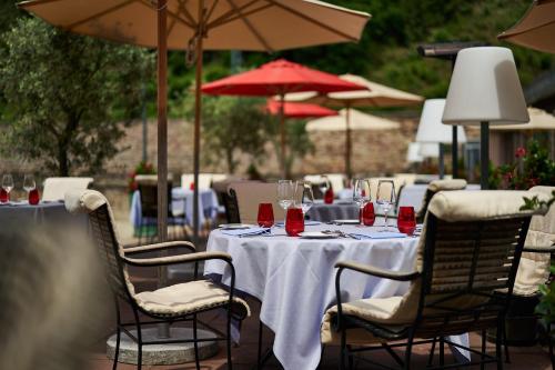 a table with wine glasses on it with umbrellas at Relais & Châteaux Hardenberg BurgHotel in Nörten-Hardenberg
