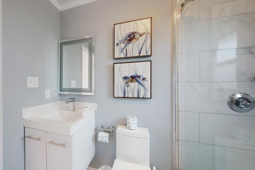 a bathroom with a toilet and a sink and a shower at Mermaid Tales in Dauphin Island