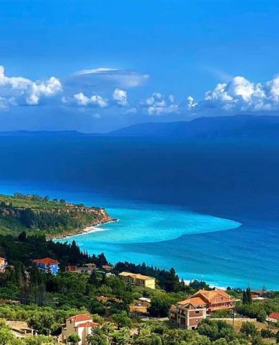 a view of the ocean from a hill with houses at Thelxis Villa in Lourdhata