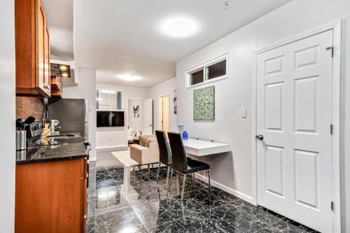 a kitchen with a white door and a table and chairs at Cozy 1BD steps away from Convention Center in Philadelphia