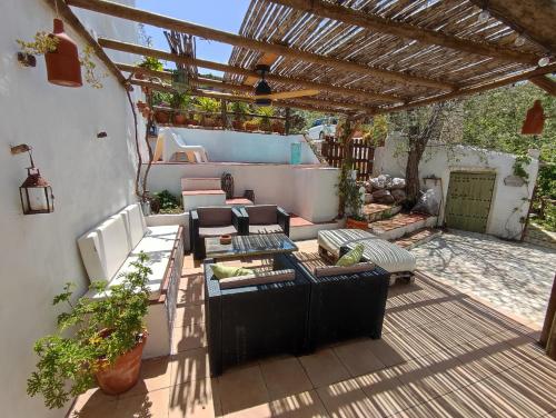 a patio with couches and chairs under a pergola at Cortijo Aldamuz-VTAR102 in Oria