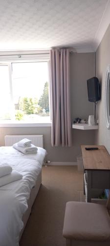 Postel nebo postele na pokoji v ubytování CORSBIE VILLA GUEST HOUSE