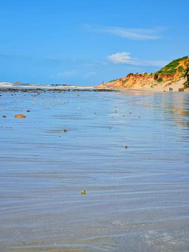 a beach with sand and the ocean at Casa da Peroba Sol - Pé na Areia - Praia da Peroba - Icapuí in Icapuí