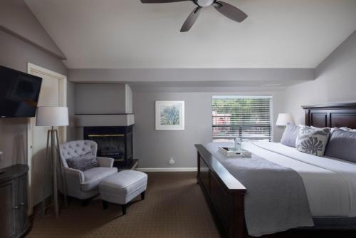 a bedroom with a large bed and a chair at Inn Above Oak Creek Sedona in Sedona