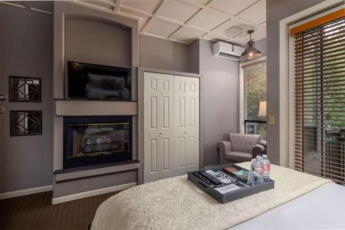 a bedroom with a bed with a fireplace and a tv at Inn Above Oak Creek Sedona in Sedona