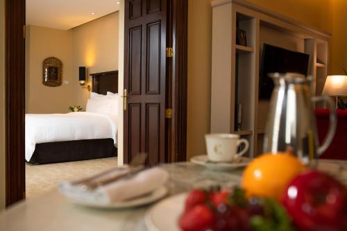 a hotel room with a bed and a table with fruit at Country Club Lima Hotel – The Leading Hotels of the World in Lima