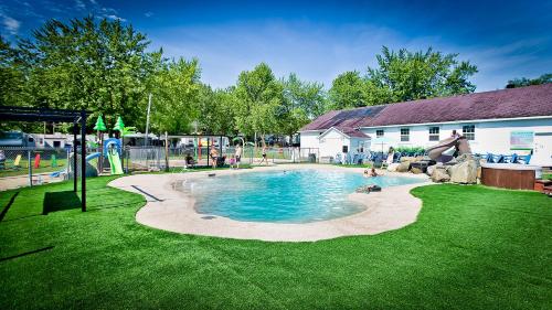 una piscina en un patio con gente jugando en ella en Auberge Papillon Lune, en Richmond