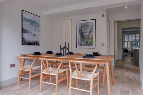 a dining room with a wooden table and chairs at Andrean House, St Andrews in St. Andrews
