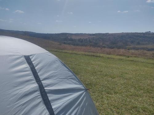 a white tent sitting on top of a field at Cachoeira do Alemão - Recanto dos Arcos in Balsa Nova