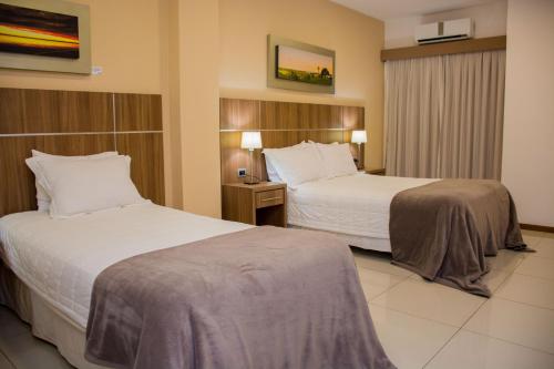 Cette chambre comprend 2 lits et une fenêtre. dans l'établissement Bella Vista Hotel - Encarnación, à Encarnación