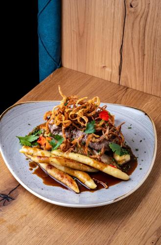 a plate of food with pasta and french fries on a table at Hotel & Restaurant Herzstück Waldkirchen in Waldkirchen