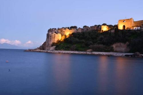 a large body of water with a castle in the background at FOTIS HOUSE in Koroni