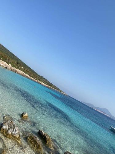 a view of a beach with blue water and rocks at FOTIS HOUSE in Koroni