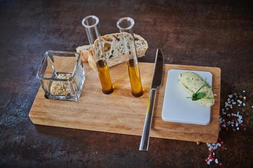 a cutting board with a knife and a plate of bread at Hotel & Restaurant Herzstück Waldkirchen in Waldkirchen