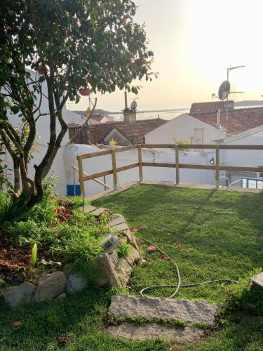 a garden with a hose on the grass at Bom Caminha - Private Albergue for Pilgrims in Caminha