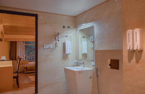 a bathroom with a sink and a mirror at Treenz Hotel in Gangtok