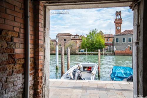 a boat is docked in a body of water at MURANO Place - RIVA House in Murano