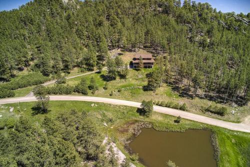 an aerial view of a house on a mountain with a road at Eagle Pine Lodge in Custer