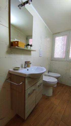 a bathroom with a sink and a toilet and a mirror at Villa Manto Bed and Breakfast - Torre Annunziata Pompei in Torre Annunziata
