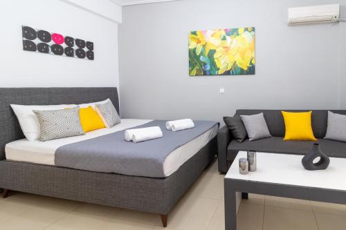 a bedroom with two beds and a couch at K6 Fashion Sparta Apartment in Sparti