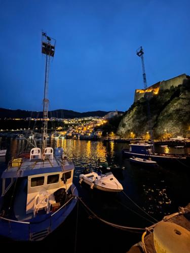 a group of boats docked in a harbor at night at Il Bocciolo - Locazione turistica in Scilla