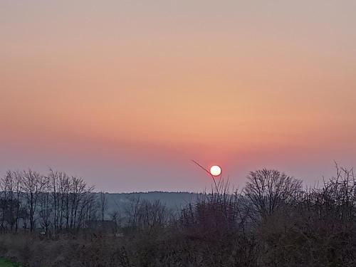 a sunset with the sun in the sky at Le Clos Fleuri in Sautin