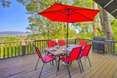 a table with chairs and a red umbrella on a deck at Bring Your Pets! Chattanooga Home with Dtwn Views in Chattanooga