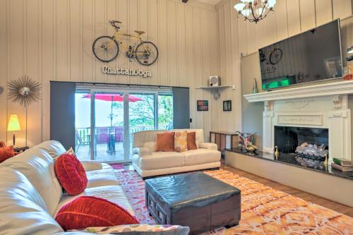 a living room with a couch and a bike on the wall at Bring Your Pets! Chattanooga Home with Dtwn Views in Chattanooga