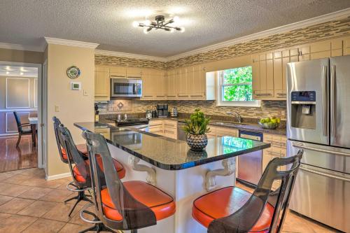 a kitchen with a island with chairs and a refrigerator at Bring Your Pets! Chattanooga Home with Dtwn Views in Chattanooga