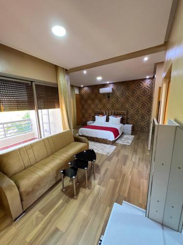 a living room with a bed and a couch at Villa Haitam Marrakech in Oubadine