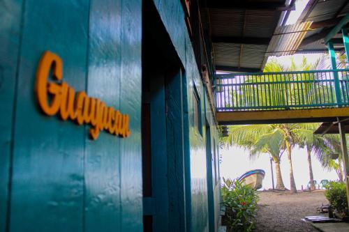 a blue building with a sign on the side of it at Refugio Mr Jerry Eco House in Bahía Solano