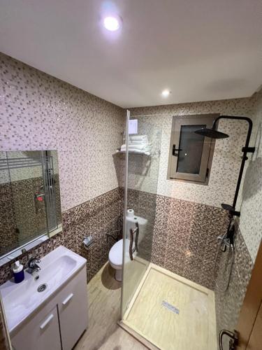 a bathroom with a shower and a sink and a toilet at Villa Haitam Marrakech in Oubadine