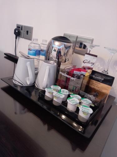 a tray with cups and a coffee maker on a table at The Gatsby Blackpool - Formerly The Windsor in Blackpool