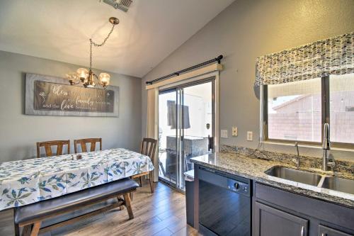 a kitchen and dining room with a table and a sink at Avondale Retreat with Grill - 15 Mi to Phoenix! in Avondale