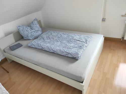 a bed with two pillows on it in a room at Beautiful 2 bedroom apartment in a quiet area in Kretzschau