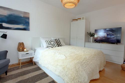een slaapkamer met een wit bed en een tv bij Izola Dreamy Stays KORD in Izola