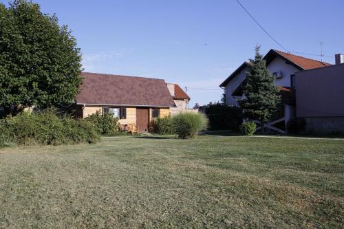 a house with a yard with a house at Apartments Osijek by the River in Osijek