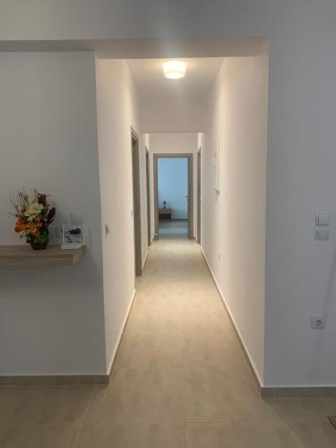 a hallway of a building with white walls and tile floors at KOS SUITE HOME in Platánion