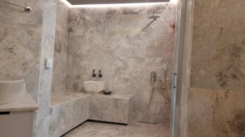 a bathroom with a shower and a sink at Ürgüp Inn Cave Hotel in Urgup