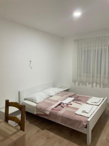 1 dormitorio con 1 cama y 1 silla en Sobe Klara, en Međugorje