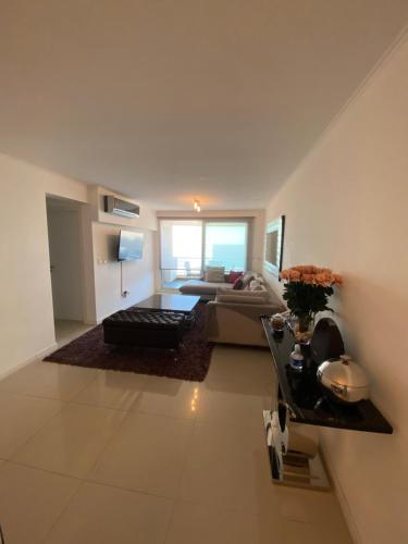 a large living room with a couch and a table at Wind Tower Punta del Este in Punta del Este