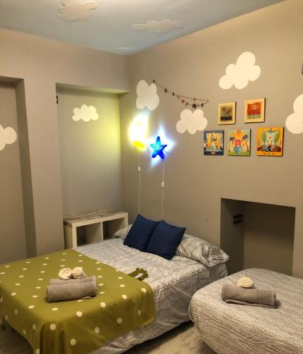 a bedroom with two beds and a star on the wall at Atico3 - Ciudad de Berja in Berja