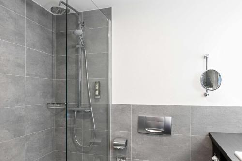 a shower with a glass door in a bathroom at Radisson Blu Hotel Bremen in Bremen