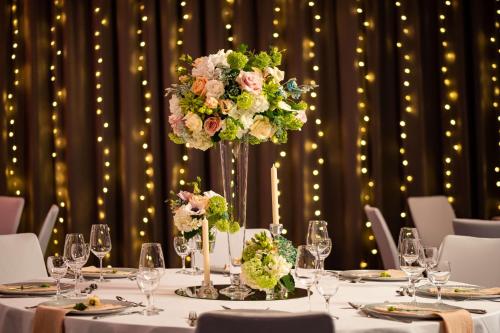 a table with a vase of flowers on it at Radisson Blu Hotel Bremen in Bremen