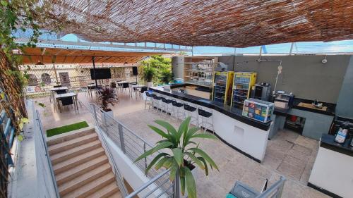 an overhead view of a restaurant with a counter and tables at Magdalena Imperial Hotel By GHO Hoteles in Girardot