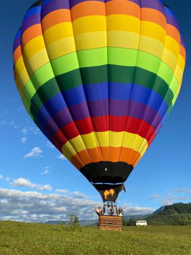 a colorful hot air balloon in a field at Pousada & Camping Nativos dos Canyons in Praia Grande