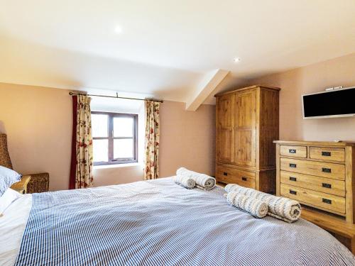 a bedroom with a large bed with two pillows on it at The Hayloft in Whaley Bridge