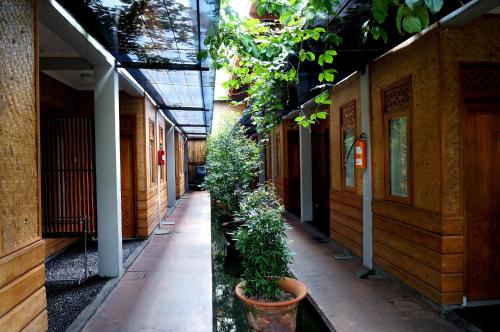 an empty hallway with plants in a building at Kampung Sumber Alam Garut in Garut