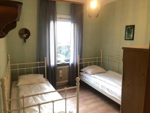 two beds in a room with a window at Ferienhaus in Willingen nahe Skipisten in Willingen