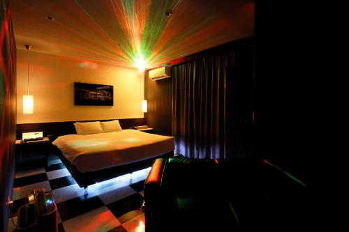 a hotel room with a bed and a couch at 555 MOTEL GOTEMBA in Gotemba